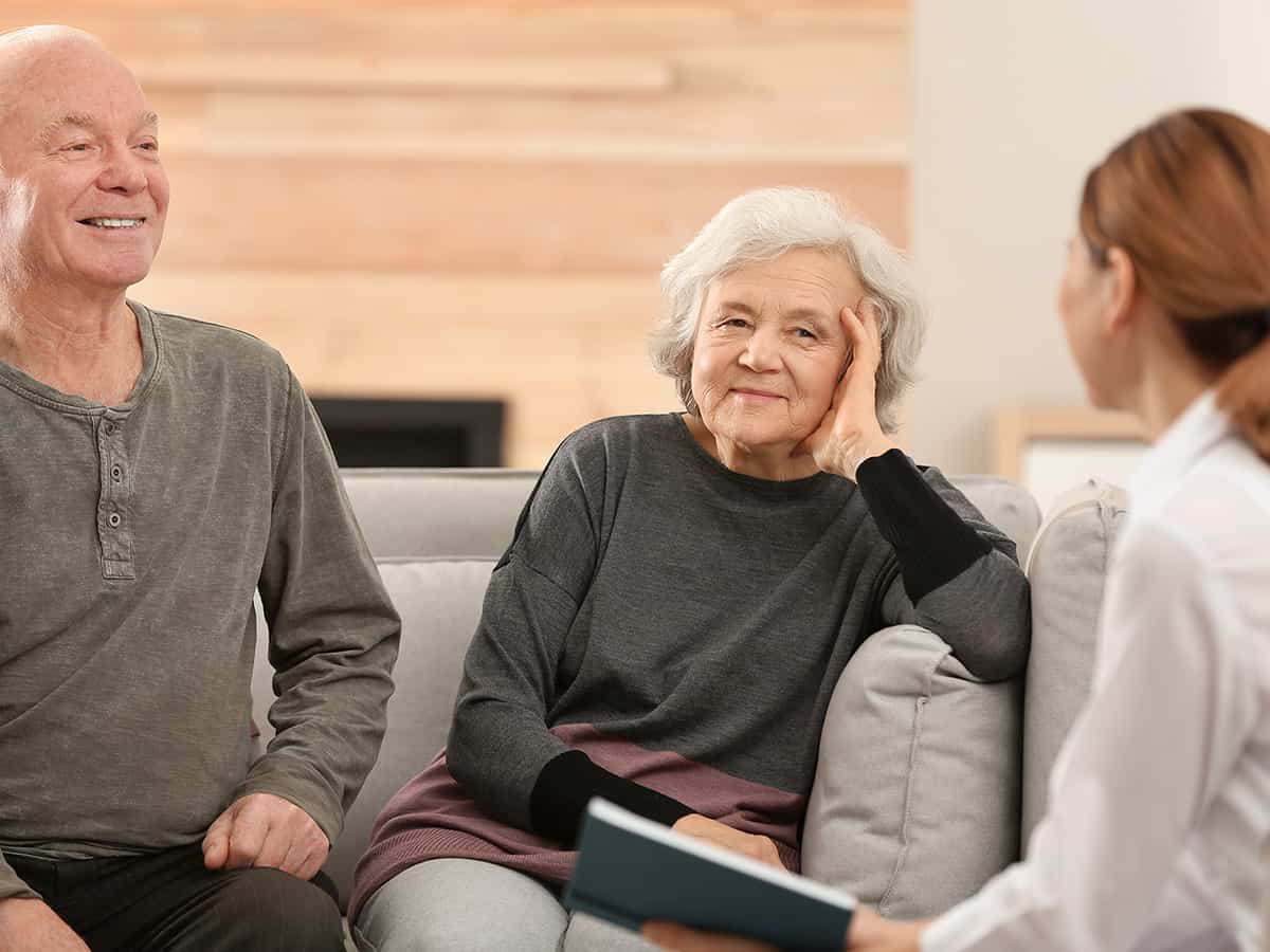 Image of an elderly couple talking to a nurse