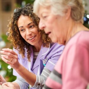 img of someone caring for an older woman