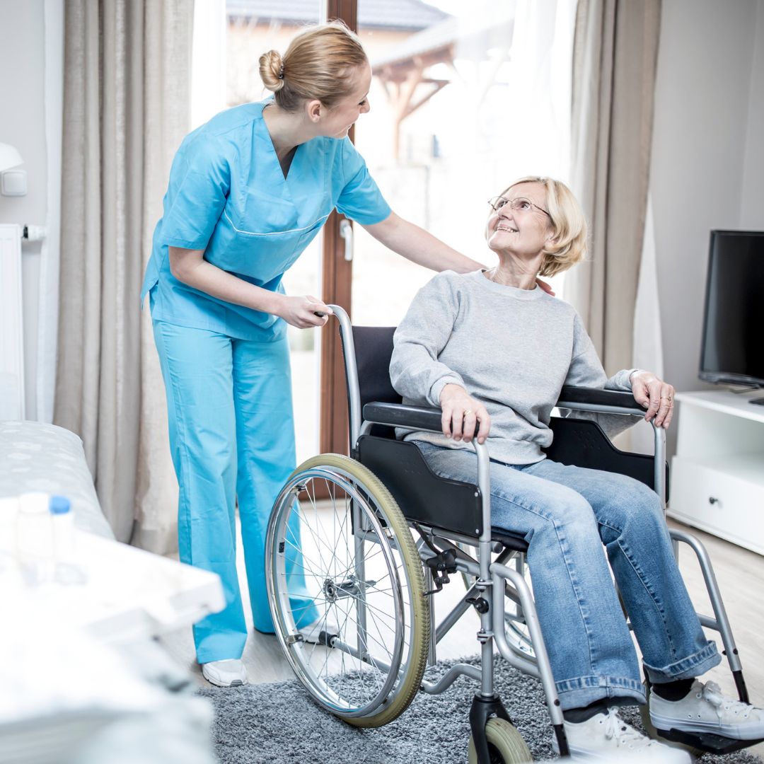 senior in wheelchair with in-home caretaker