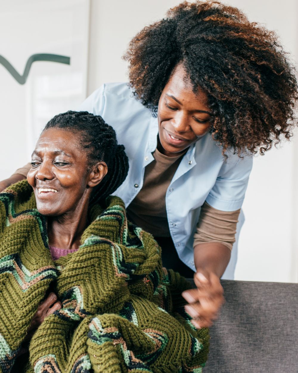 a nurse giving a woman a blanket