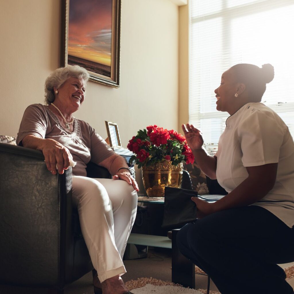 A patient and care provider laugh together