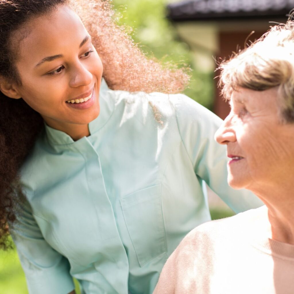 An in-home care expert smiles at her client