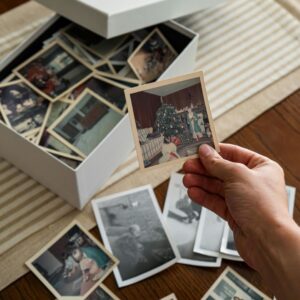 hand holds family photos from box 